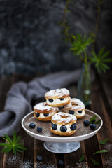 Cream puff rings (choux pastry) decorated with fresh blueberries