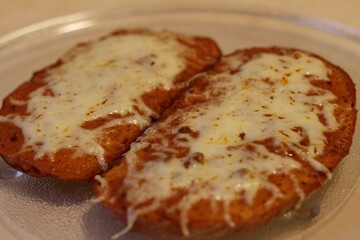 Hot sandwich with cheese on the glass plate