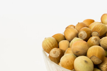ripe hazelnuts in a peel on a white background