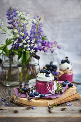 Obraz na płótnie Canvas Blueberry Panna Cotta decorated with cream and fresh berries