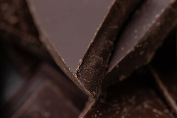 Dark chocolate cracked pieces closeup macro