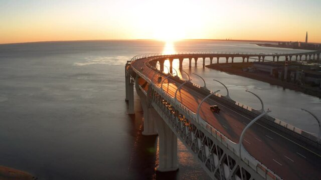High-speed toll road, highway bypassing the city center St. Petersburg, the central section of the western high-speed section. A beautiful view of the sunset over the Gulf of Finland.