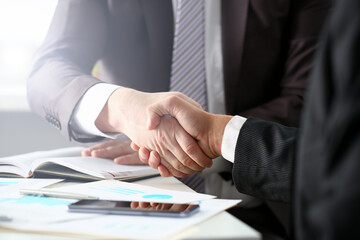 Man in suit shake hand as hello in office closeup. Friend welcome mediation offer positive introduction greet or thanks gesture summit participate approval motivation strike arm bargain concept