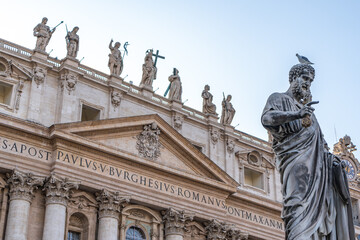 Fototapeta na wymiar Statue of Saint Peter and Saint Peter's Basilica at background in St. Peter's Square, Vatican City, Rome