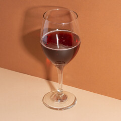 Wineglass on the withe table. Shadow of glass. Light background. Red wine for your evening. Restaurant menu. enjoy your life.