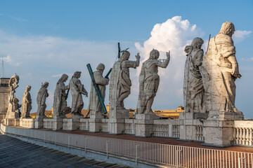 Statue of Saint Peter and Saint Peter's Basilica at background in St. Peter's Square, Vatican City, Rome
