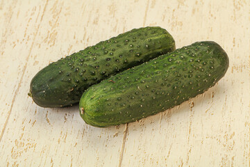 Green fresh cucumbers over background