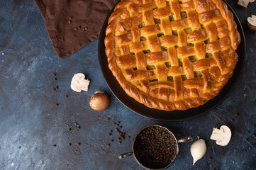 Mushroom pie on blue background. Tasty pie. Cooking together. Homemade food. Fragrant pie.