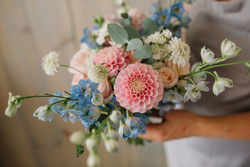 The original bouquet of flowers in the hands of women