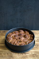 Cinnamon rolls on wooden background. Baking
 on grey background