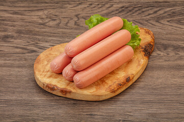 Tasty meat sausages over board