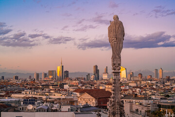 View of the statues on the Cathedral of Milan and the skyline of Milan seen on the background