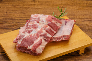 Raw pork ribs served rosemary
