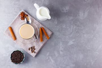 Masala chai tea. Traditional indian drink - masala tea with spices on gray background. Copy space. Top view