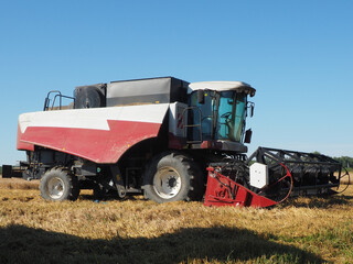 the combine-harvester for harvesting grain crops. harvesting barley. farm. large agricultural machinery.