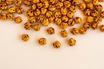 Roasted yellow chickpeas background on white with copy space.Top view