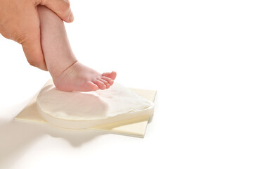 Taking the shape of a newborn baby's foot over white background.