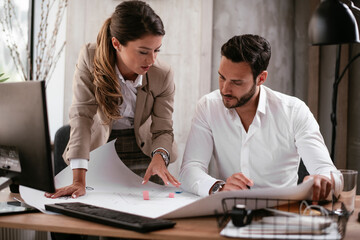 Businessman and businesswoman in office. Businesswoman and businessman working on the project