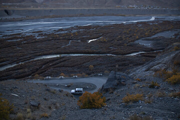 Natural textures and strange patterns off hills and rivers of Spiti Valley - light and shadow, tourist vehicle and birds