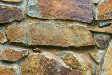 Wall made of rusty stone blocks. Texture of stone wall for wallpaper, background