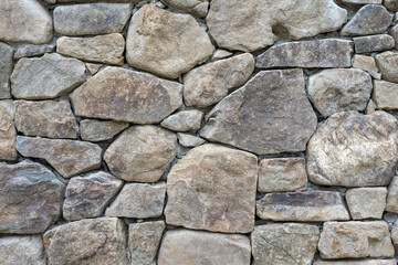 Gray stone blocks with gaps placed on the cement wall, texture, background 
