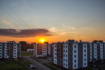 orange sunset over a five-story residential complex