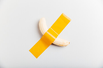 Banana taped on the wall by scotch tape. Art concept