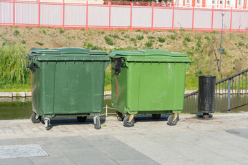 large plastic trash cans on the city waterfront
