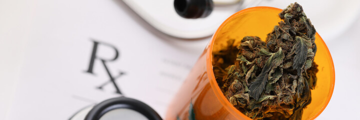 On table stethoscope and medicinal jar marijuana. Drug effect cannabis in restoration neuron membranes. Doctor weighs benefits and risks using marijuana. Prescription organic marijuana