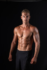 Fototapeta na wymiar handsome muscular topless man on studio background, sport