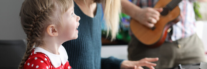 Parents teach daughter to play musical instruments. Develop logical thinking and creativity. Development musical art, genres. Long-term hard work. Parents monitor quality classes