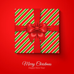 Merry Christmas Greeting Card with Christmas Gift Box. Res Silk Ribbon Bow and Striped Wrapping Paper. Vector illustration. Happy New Year Season Greetings Banner Concept.
