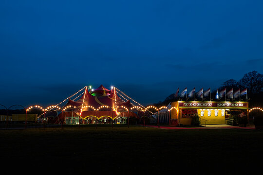 Night view of a circus tent under a blue hours sunset and clean blue sky