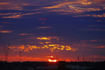 Electric energy tower silhouette on sunset sky