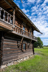 vintage houses and churches wooden architecture north in summer against blue sky background