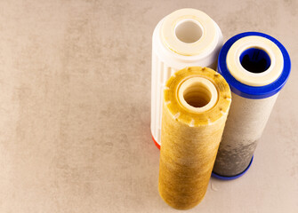 there are three filters on the table after replacing dirty drinking water.copyspace for text.