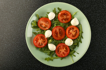 caprese salad top view on black table