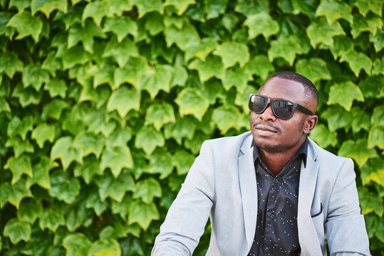 African American man sitting on a park bench