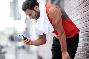 Young athlete jogging outdoors. Handsome man resting after training outdoors.