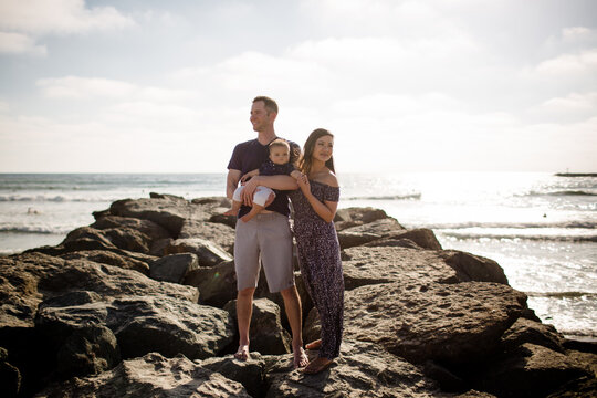 Parents Standing on Jetty Holding Infant Son