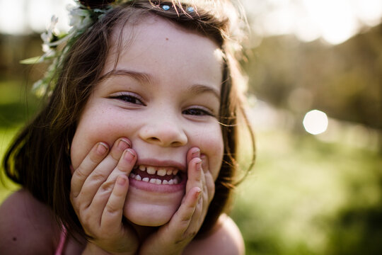 Close Up Of Young Girl In Flower Crown Being Silly