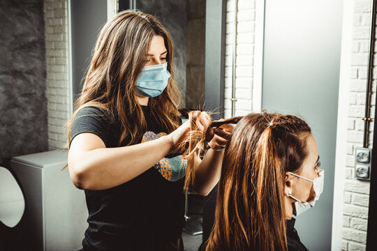 beautician and hairdresser working with mask for the covid19 virus
