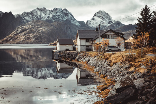 typical scandinavian house by the lake in autumn