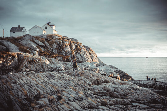 young people watching the sunset in norwegian fishing village