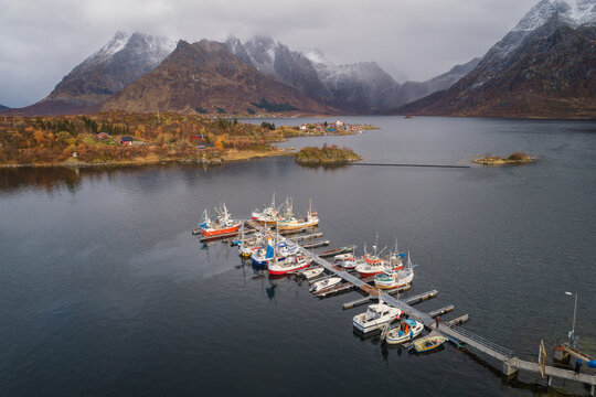 boats docked in port in lofoten fjords from drone view