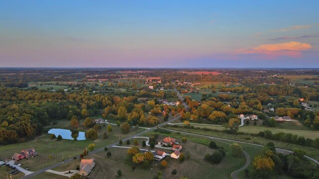 Summer landscape with field under scenic small village in sunset dawn skyline on Akron Ohio USA