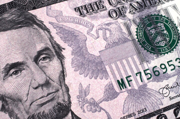 extreme close  up of five dollar bill