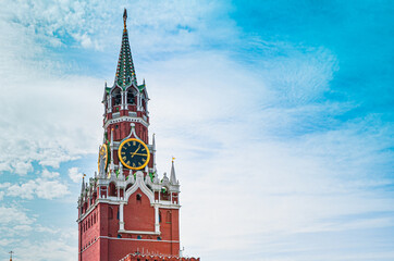 Spasskaya Tower of Moscow Kremlin against background of blue sky with cirrus clouds. Famous chimes are the main clock of Russia. Sights of Russia, a historical building, symbol of the country.