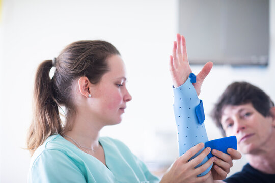 nurse tigthing a armbracer to a patient female