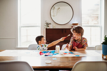 Brother and sister doing arts and crafts at home
